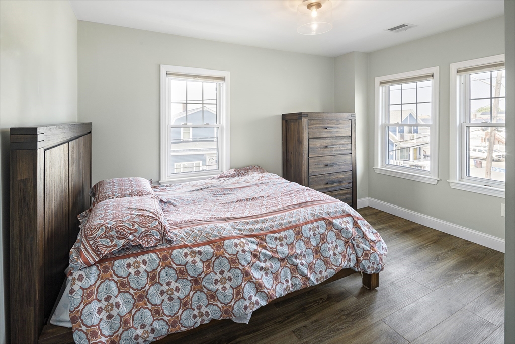 3 Clinton Road Revere, MA 02151 - Photo 7 of 19 a bedroom with a bed and wooden floor
