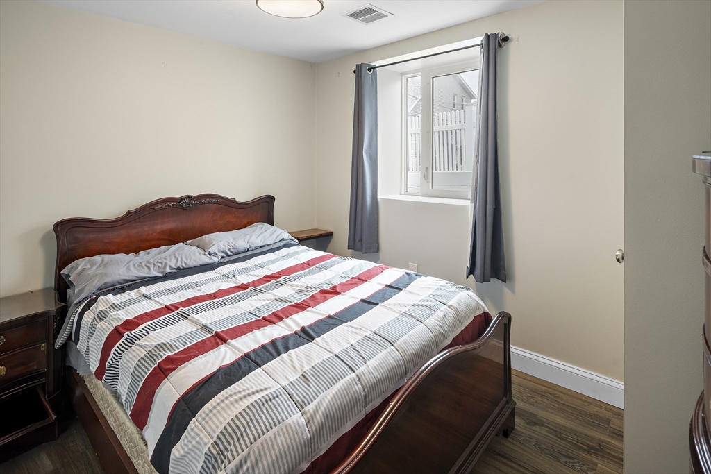 3 Clinton Road Revere, MA 02151 - Photo 8 of 19 a bedroom with a bed and wooden floor