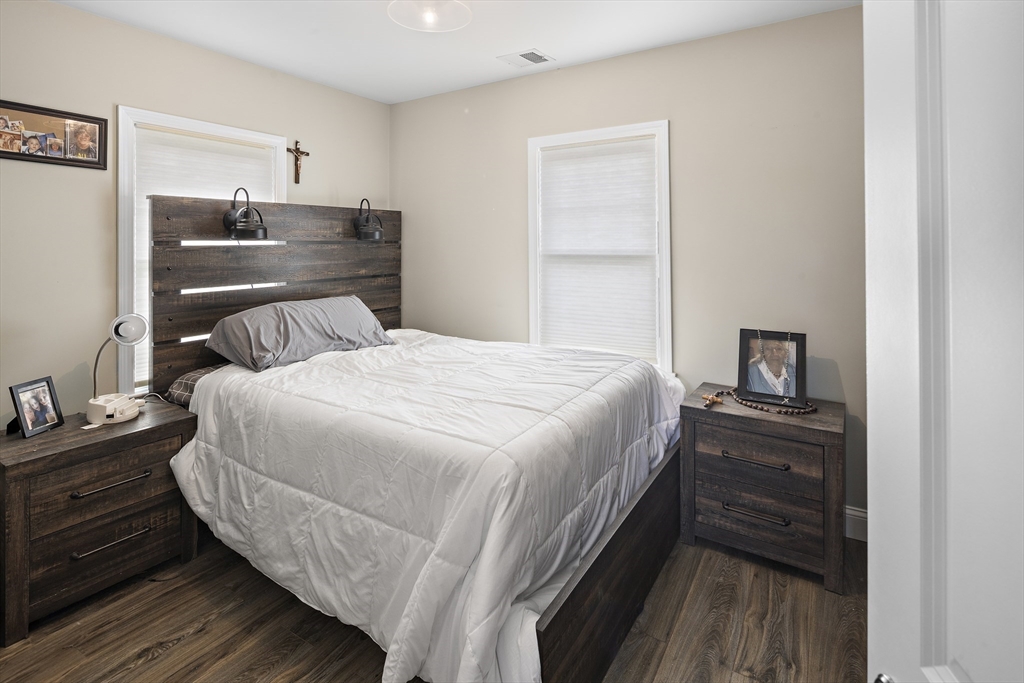 3 Clinton Road Revere, MA 02151 - Photo 9 of 19 a bedroom with a bed and wooden floor