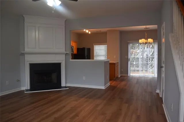 a view of a room with wooden floor and a fireplace