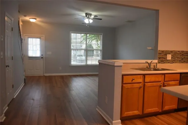 a room with a sink cabinets and wooden floor