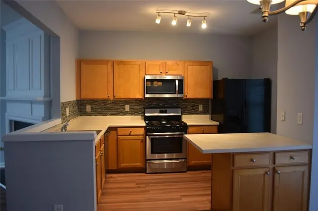 a kitchen with a stove a microwave and refrigerator