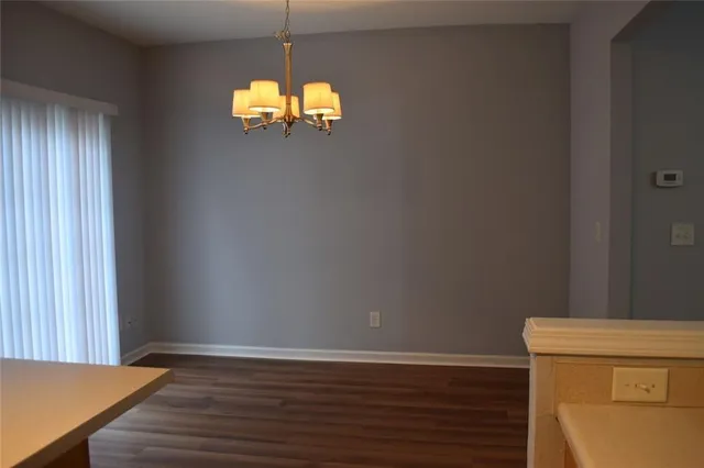 a view of a room with wooden floor and a window