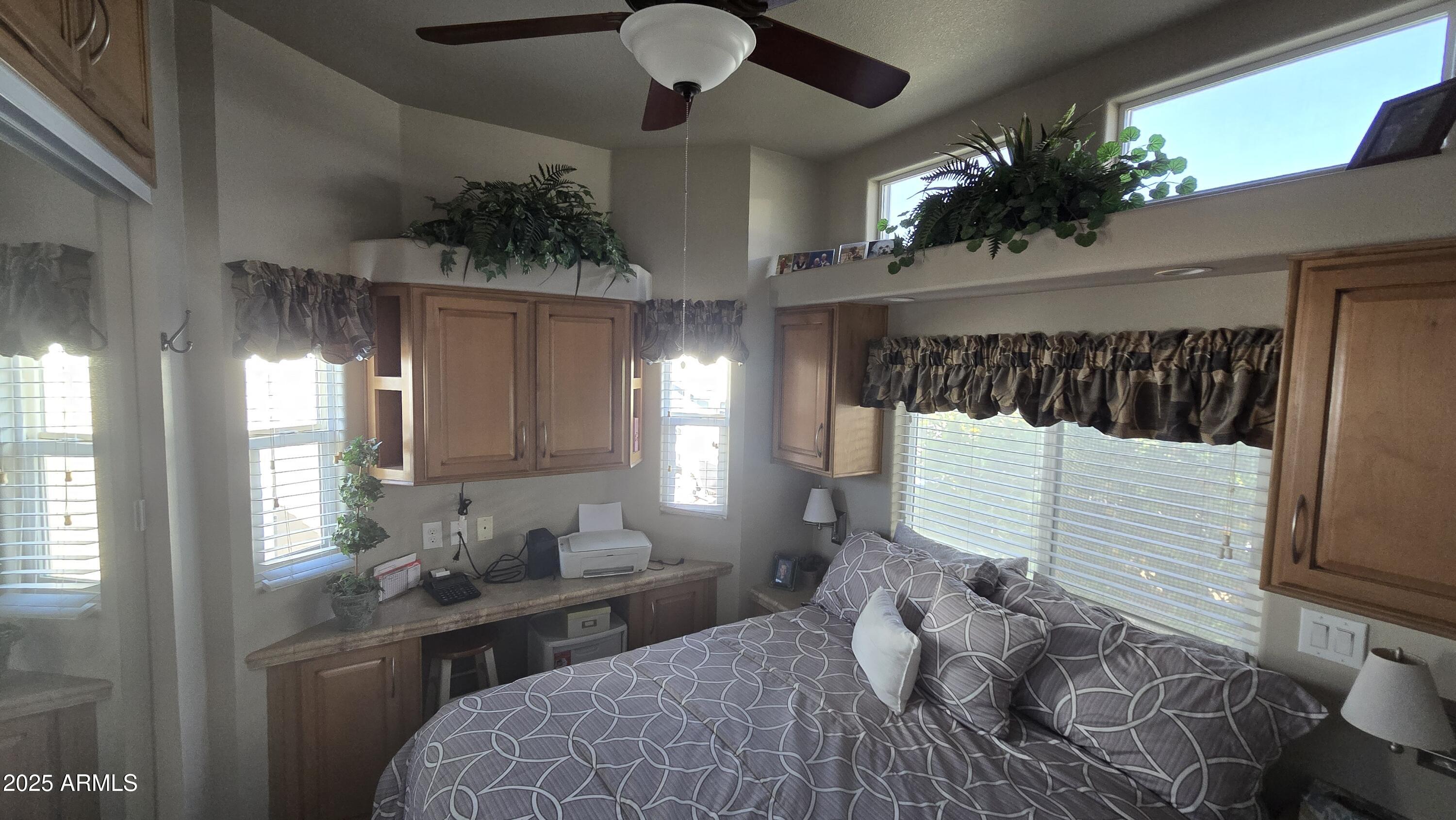17200 West Bell Road, Unit 1519 Surprise, AZ 85374 - Photo 11 of 21 a bedroom with a large bed and a large window