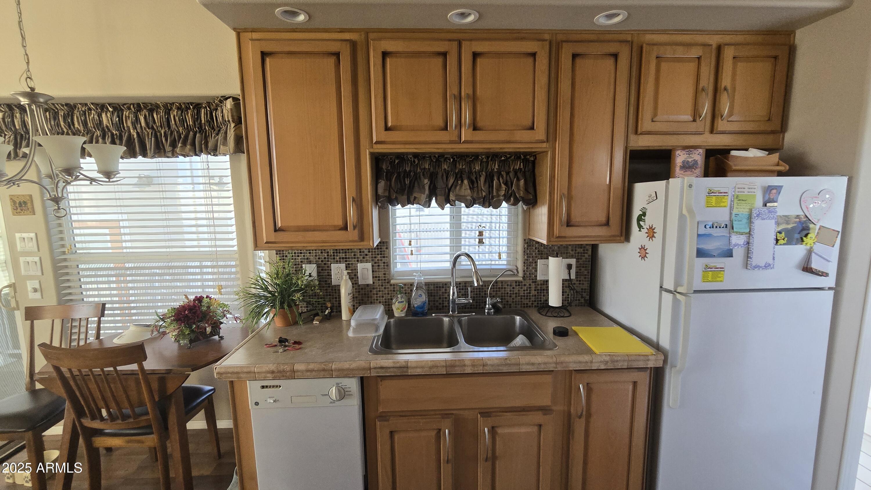 17200 West Bell Road, Unit 1519 Surprise, AZ 85374 - Photo 11 of 21 a kitchen with stainless steel appliances granite countertop a sink a stove and a refrigerator