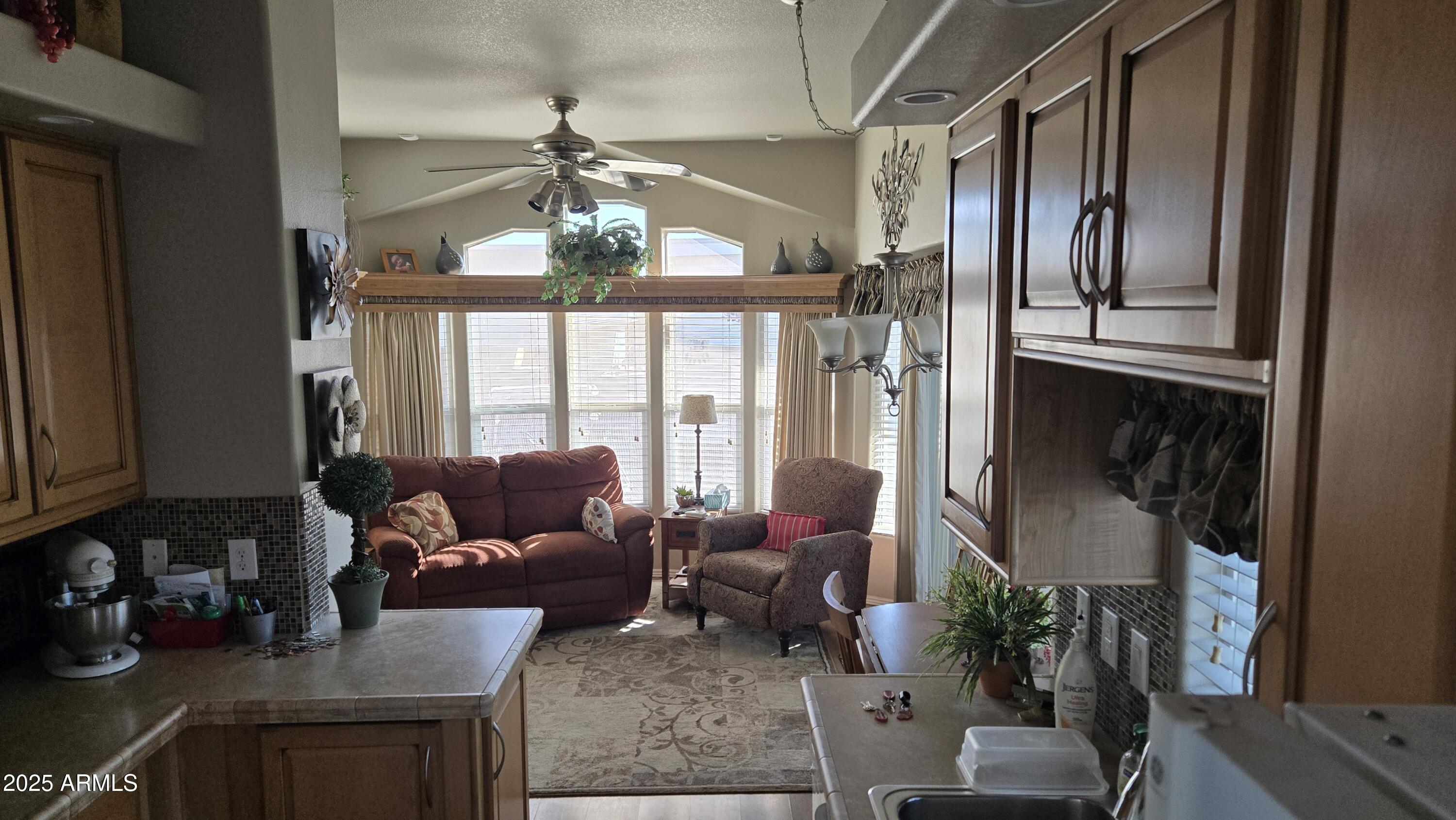 17200 West Bell Road, Unit 1519 Surprise, AZ 85374 - Photo 12 of 21 a living room with furniture and a chandelier