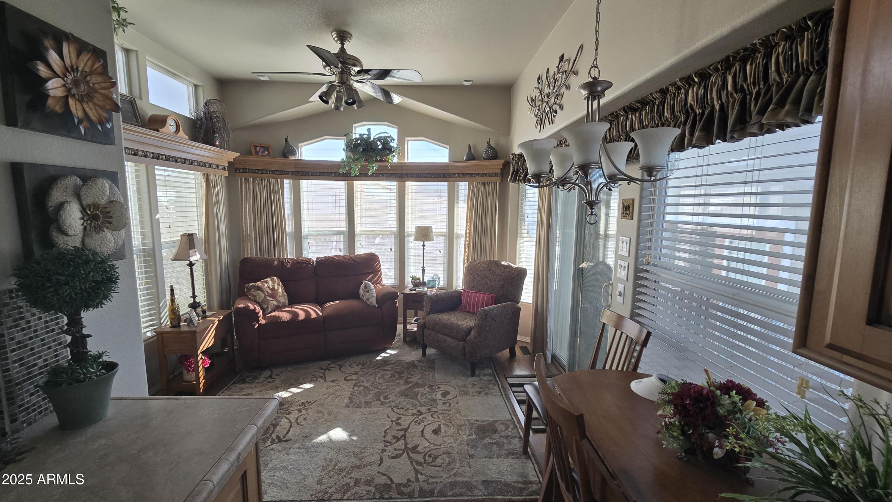 17200 West Bell Road, Unit 1519 Surprise, AZ 85374 - Photo 2 of 21 a living room with furniture and a chandelier