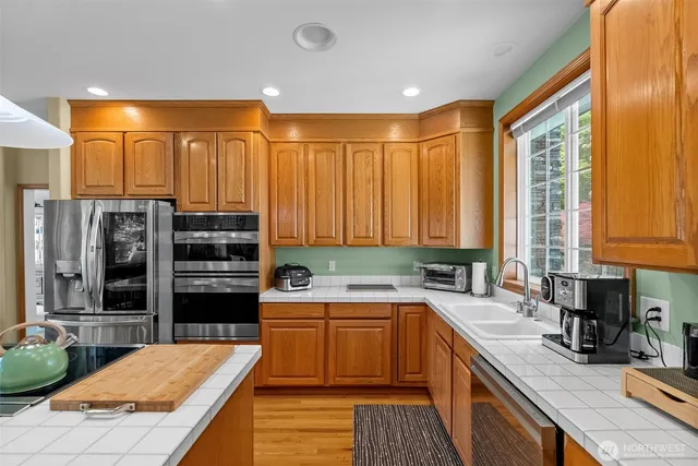 a kitchen with a sink a counter and cabinets