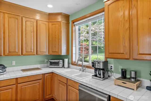 a kitchen with a sink cabinets and window