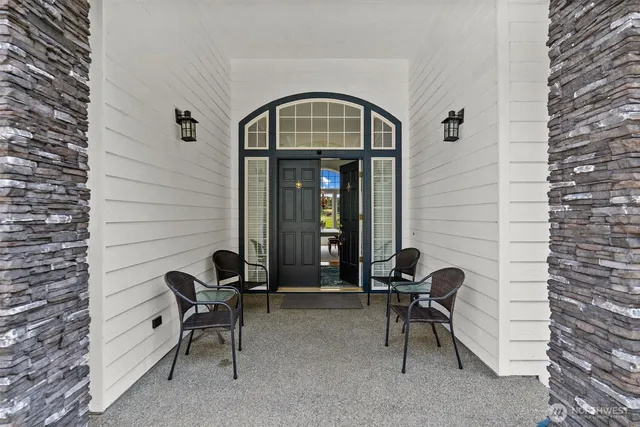 a view of front door of house with outdoor seating