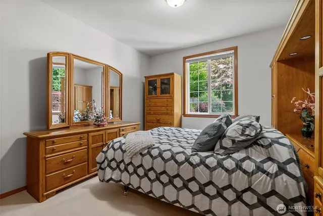 a bedroom with a bed and window with chair