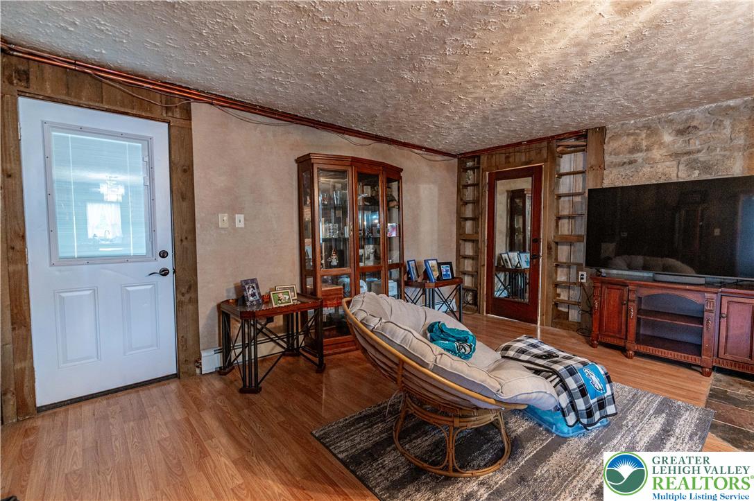 2485 Hieter Road Quakertown, PA 18951 - Photo 68 of 97 Natural wood flooring complements the rustic wall textures in this inviting room.
