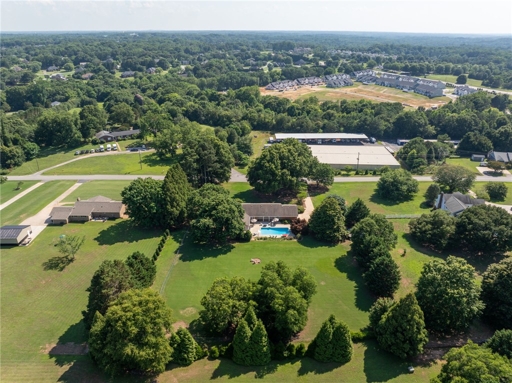3513 Hopewell Road Anderson, SC 29621 - Photo 48 of 50 An aerial perspective reveals a serene property with a sparkling pool amidst verdant grounds, surrounded by mature trees.