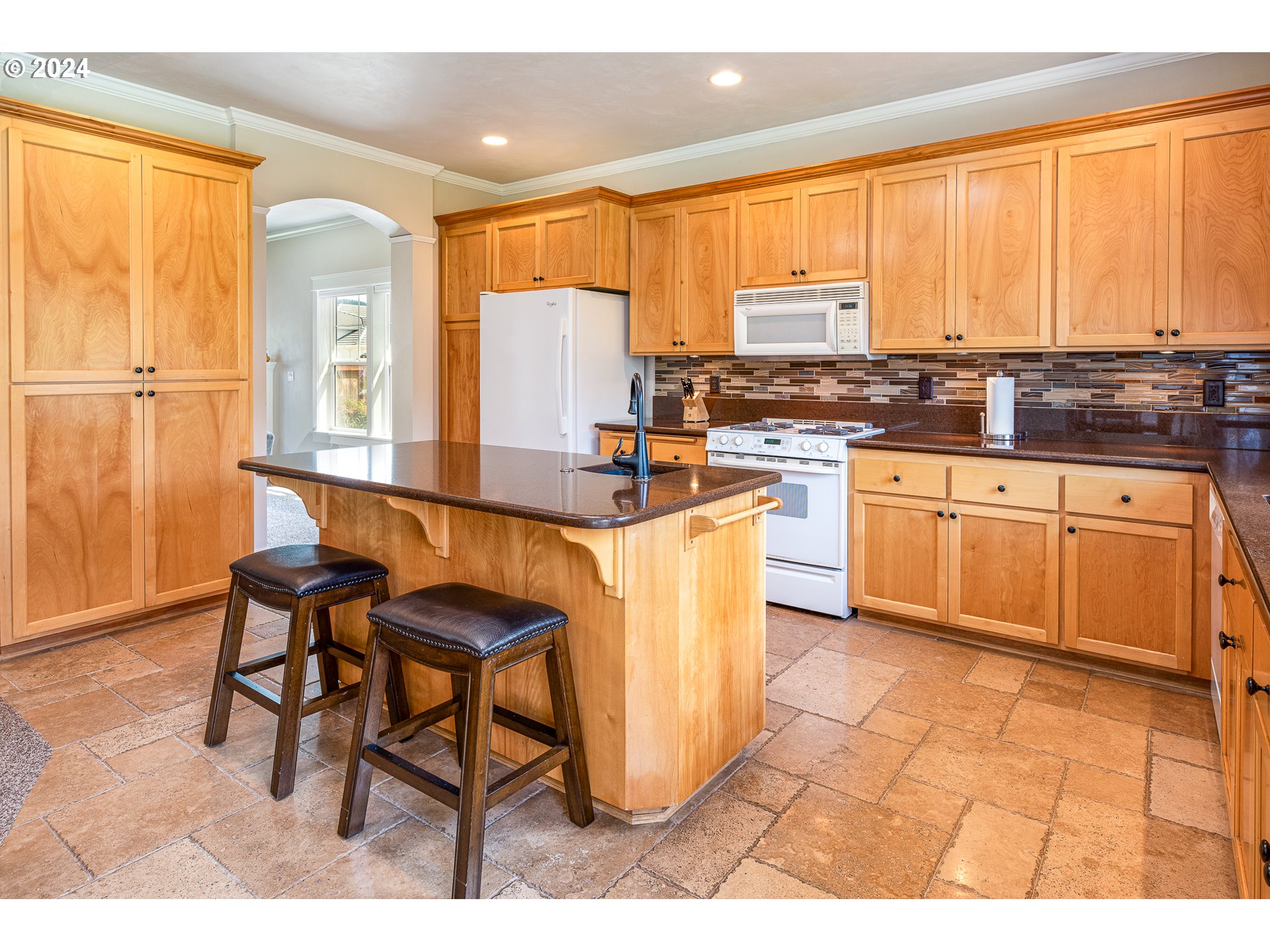 701 Blackstone Street Springfield, OR 97477 - Photo 11 of 40 a kitchen with granite countertop a stove a sink and a refrigerator