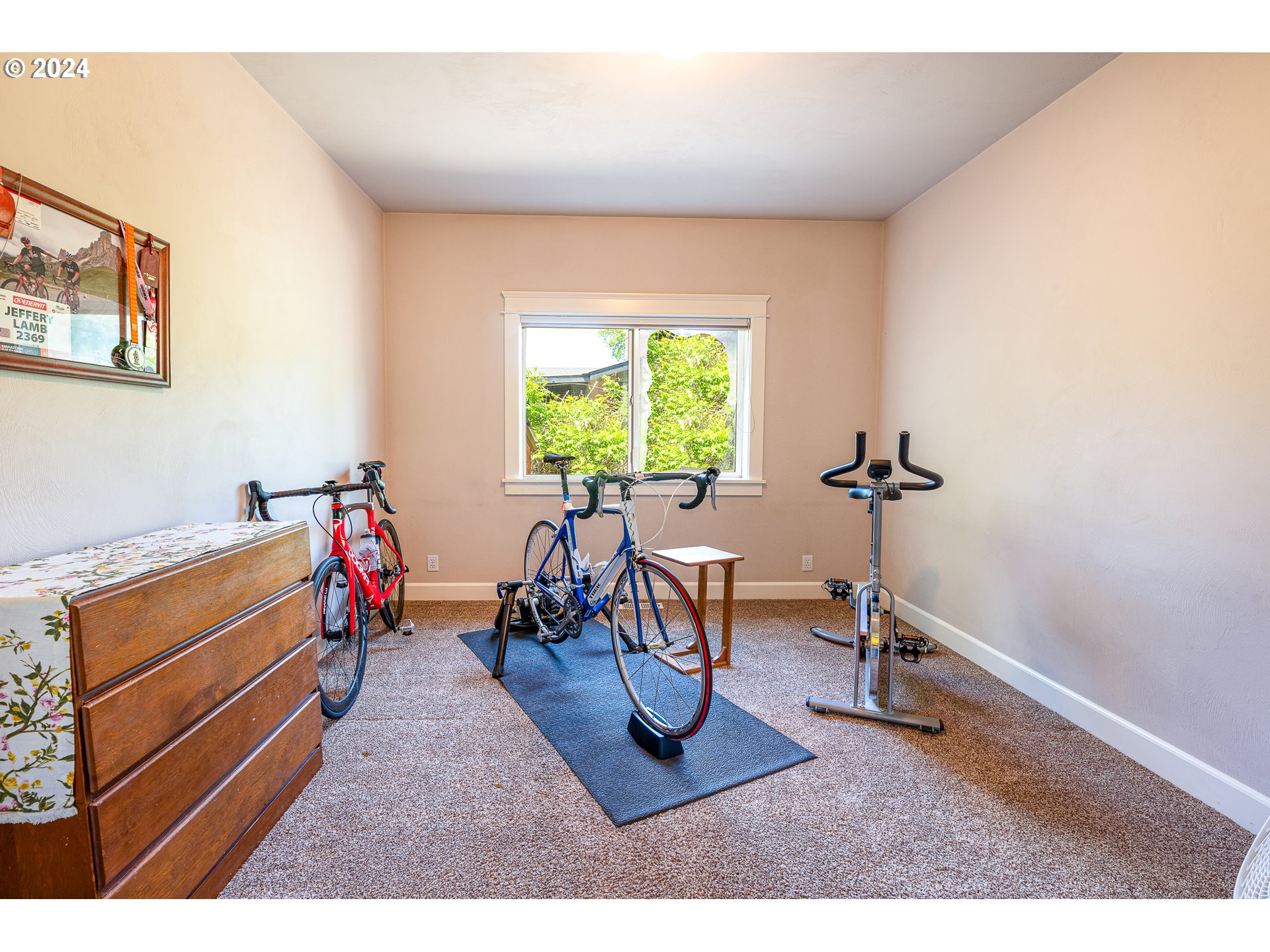 701 Blackstone Street Springfield, OR 97477 - Photo 25 of 40 a living room with furniture a window and gym equipment