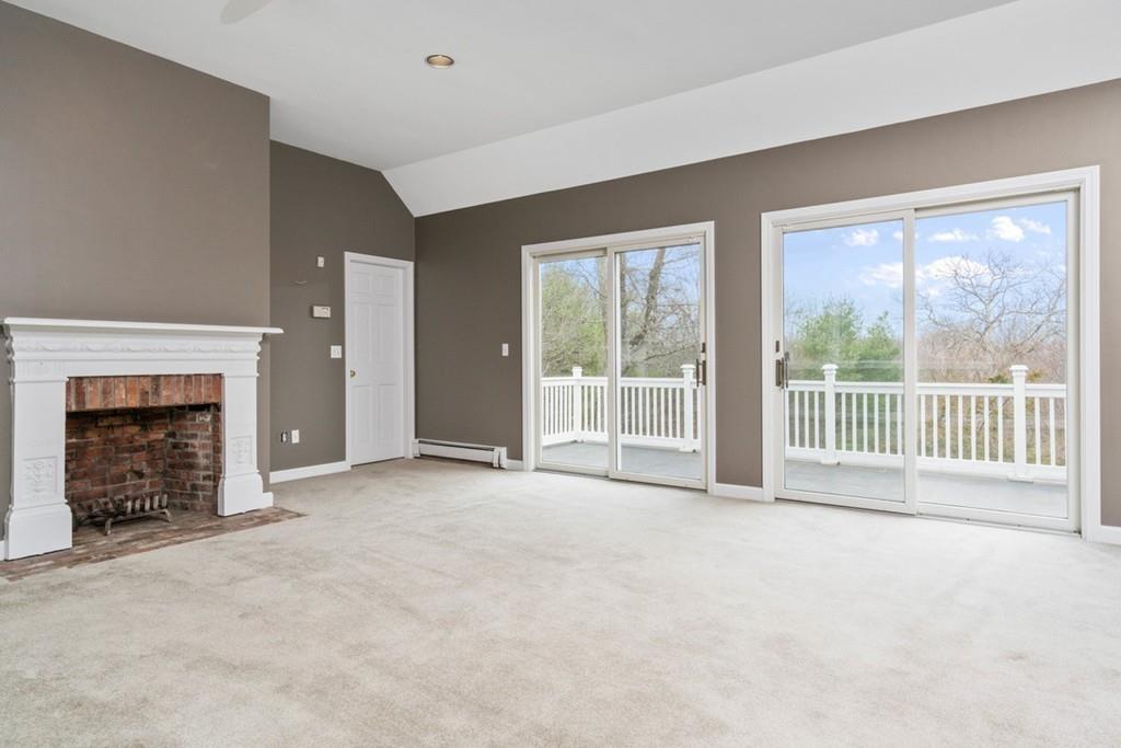 60 Schoolmasters Lane Dedham, MA 02026 - Photo 14 of 28 a view of an empty room with a fireplace and a window