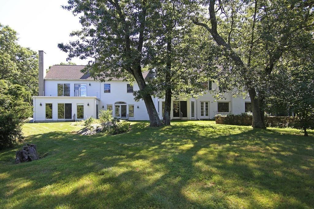 60 Schoolmasters Lane Dedham, MA 02026 - Photo 19 of 28 a front view of a house with a garden