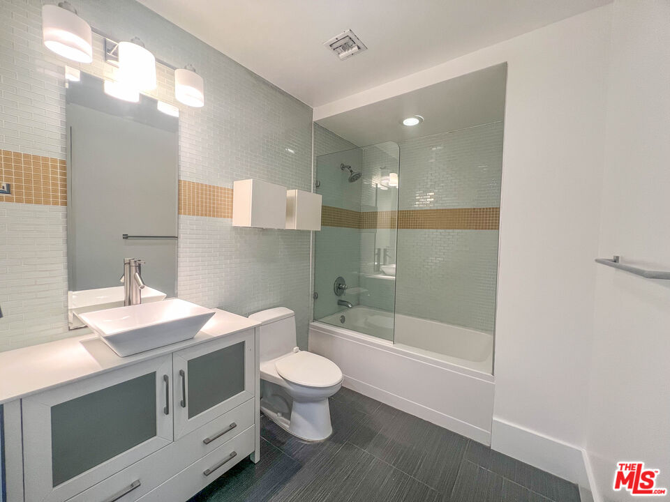 810 South Spring Street, Unit 801 Los Angeles, CA 90014 - Photo 11 of 21 a bathroom with a sink a toilet a mirror and shower