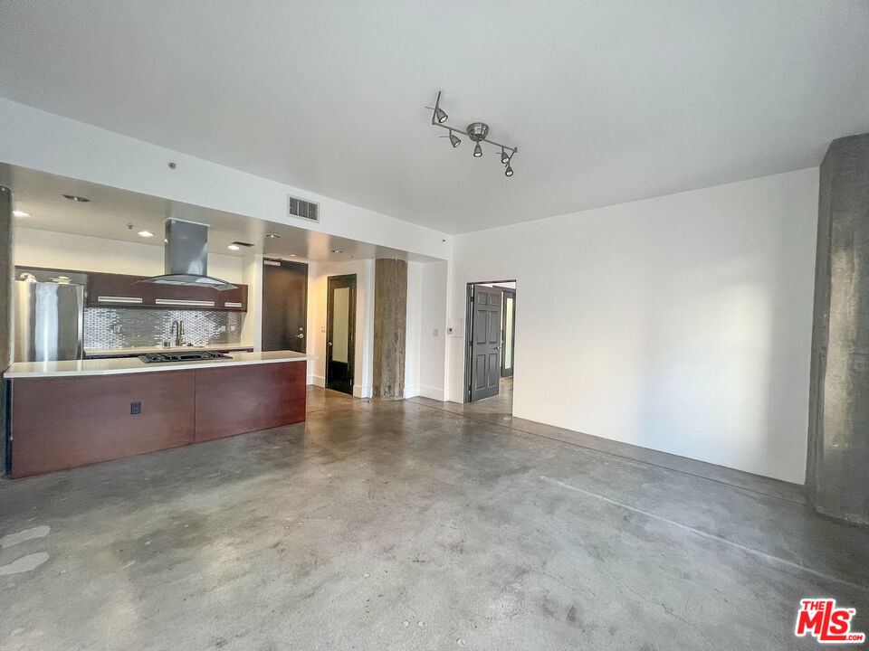 810 South Spring Street, Unit 801 Los Angeles, CA 90014 - Photo 13 of 21 a view of large kitchen with refrigerator and windows