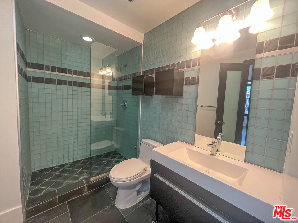 810 South Spring Street, Unit 801 Los Angeles, CA 90014 - Photo 6 of 21 a bathroom with a sink a toilet and shower