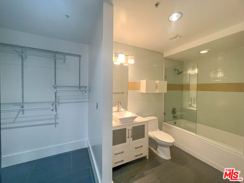 810 South Spring Street, Unit 801 Los Angeles, CA 90014 - Photo 10 of 21 a bathroom with a double vanity sink toilet and shower