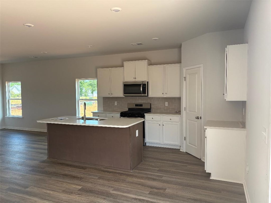 129 Cedar Shoals Easley, SC 29640 - Photo 6 of 31 A well-appointed kitchen features a central island and sleek stainless steel appliances, ready for culinary creativity.