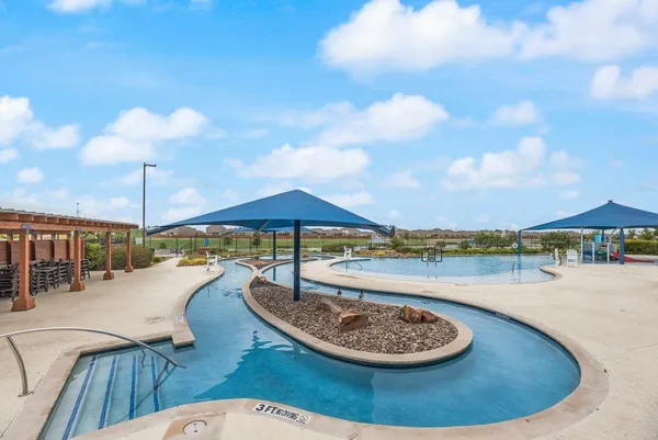 a view of a swimming pool with a patio