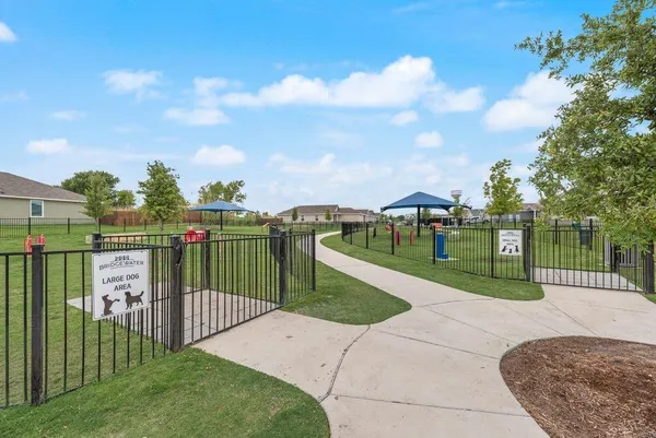 a view of a park with iron fence