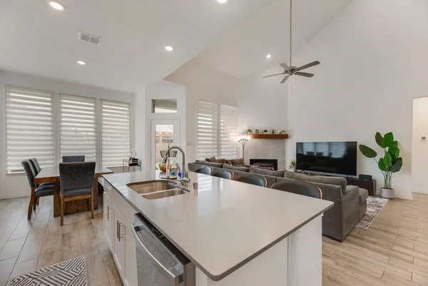 a large kitchen with sink a counter space and stainless steel appliances