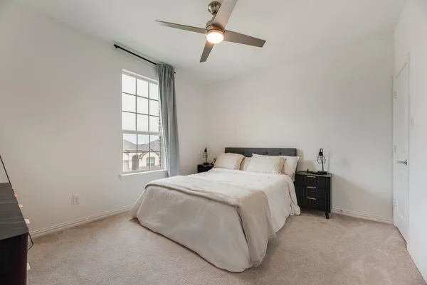 a bedroom with a bed and window