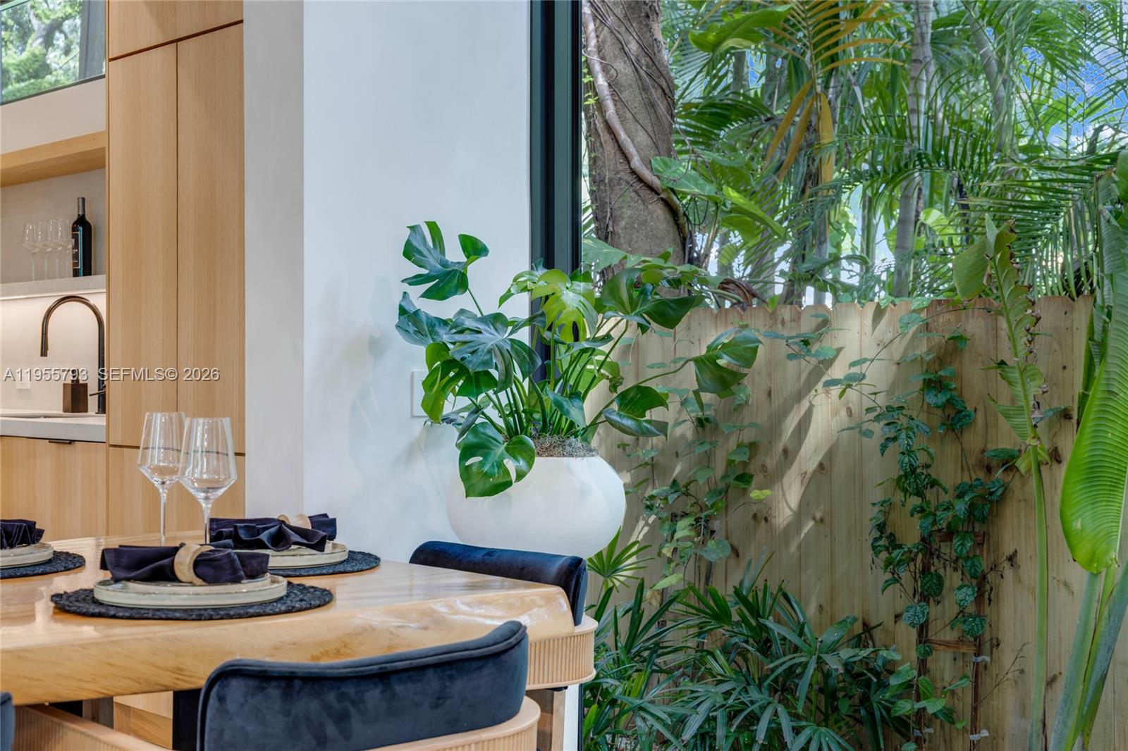 1000 Northwest 9th Court Miami, FL 33136 - Photo 13 of 43 a table with chairs and a potted plant