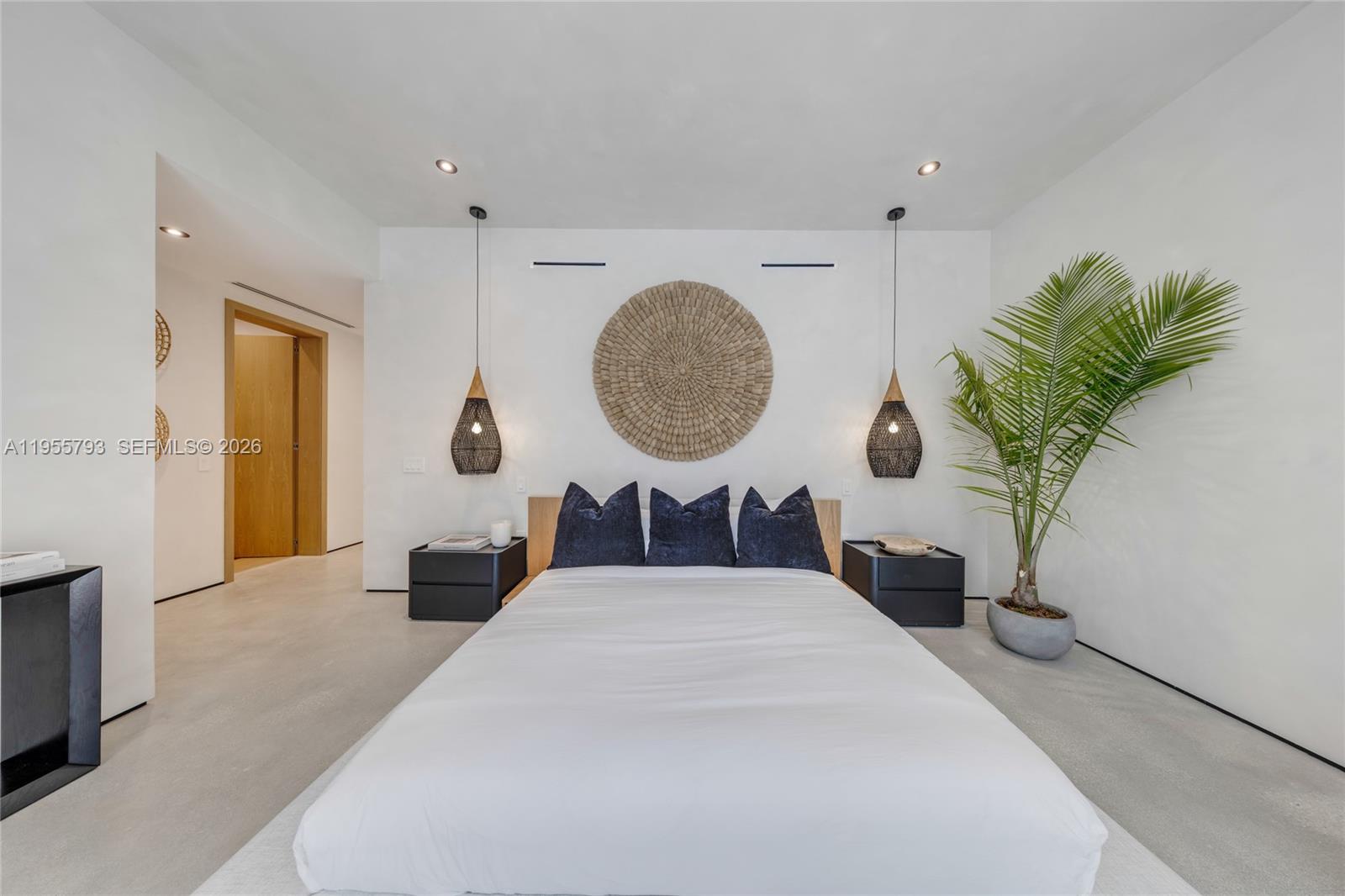 1000 Northwest 9th Court Miami, FL 33136 - Photo 29 of 43 a bedroom with a large bed and a potted plant