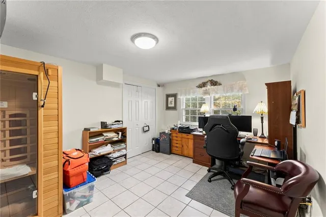 a view of a workspace with furniture and a window