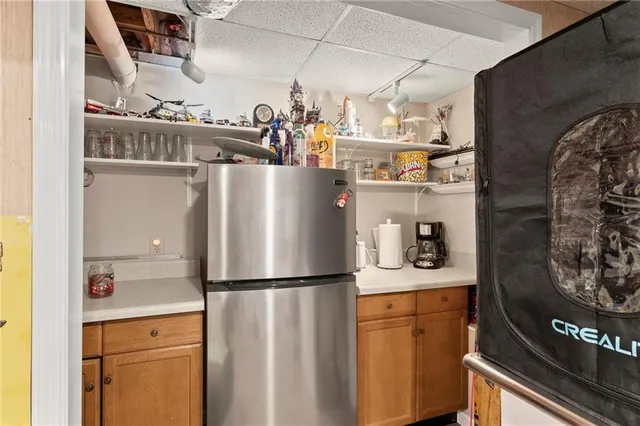 a kitchen with refrigerator and cabinets