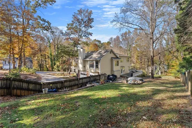 a view of swimming pool with outdoor seating and trees in the background