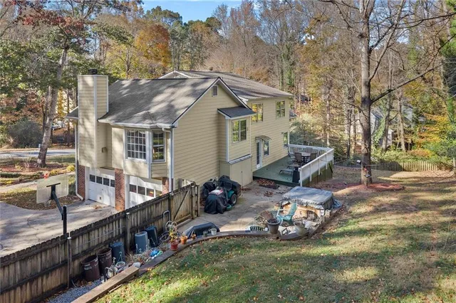 a view of a house with backyard and sitting area