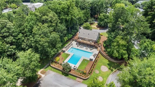 an aerial view of house with yard swimming pool and outdoor seating
