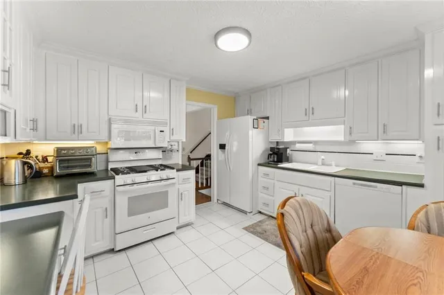 a kitchen with cabinets stainless steel appliances and a counter space