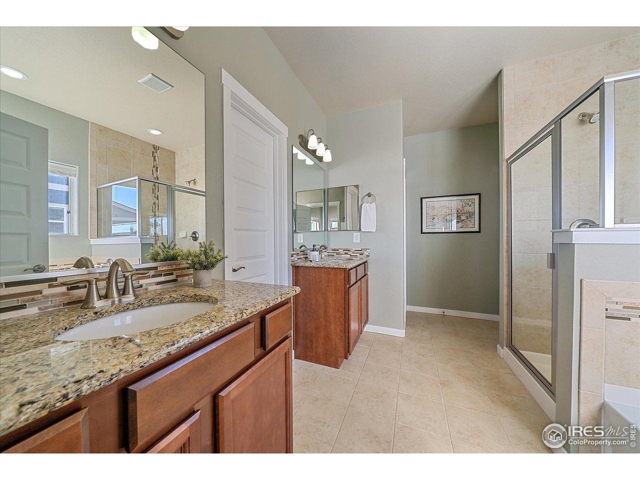 2321 Nicholson Street Berthoud, CO 80513 - Photo 11 of 22 a bathroom with a granite countertop sink mirror and double
