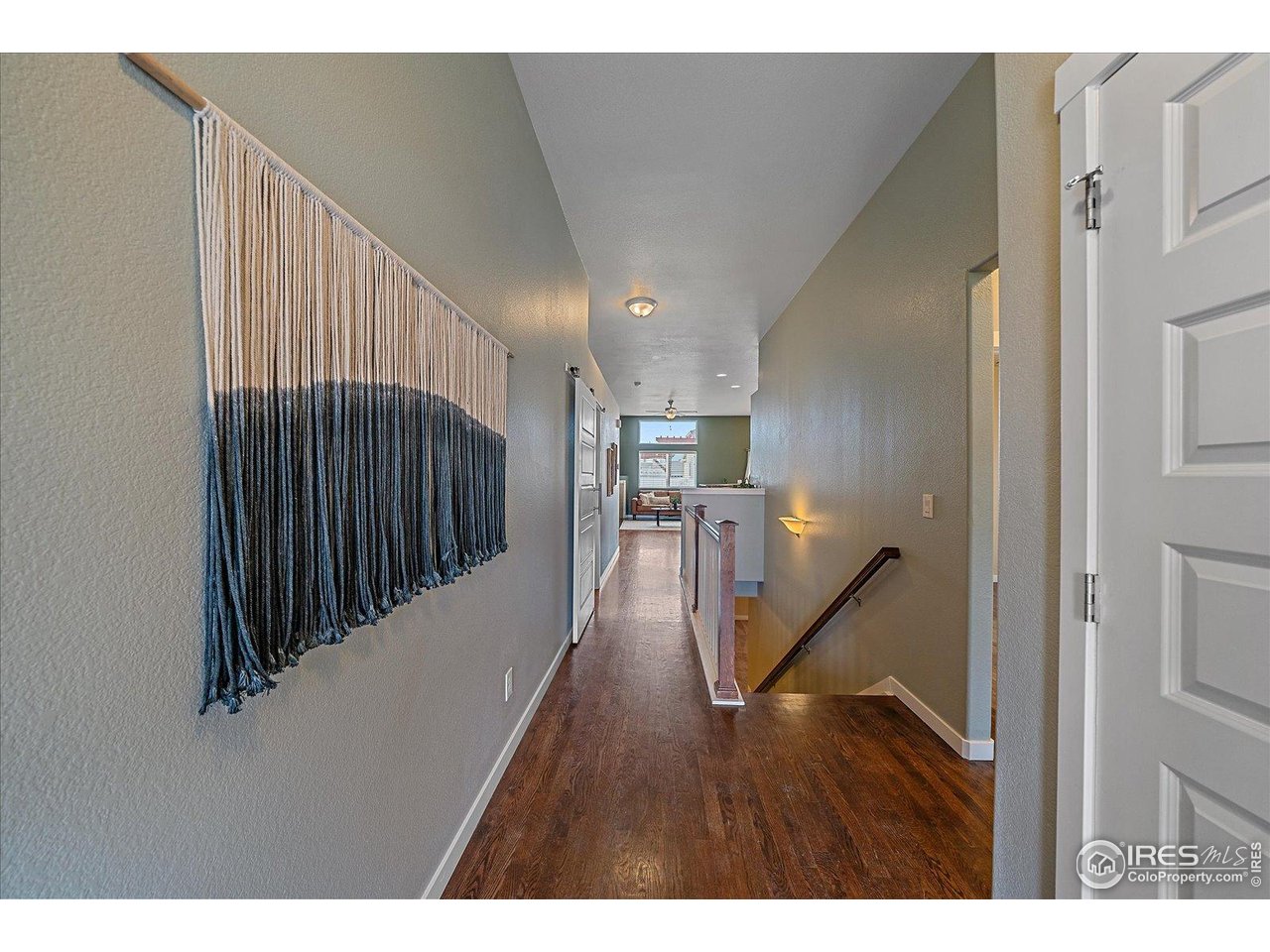 2321 Nicholson Street Berthoud, CO 80513 - Photo 3 of 22 a view of a hallway with wooden floor