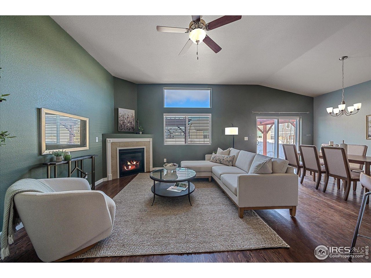 2321 Nicholson Street Berthoud, CO 80513 - Photo 4 of 22 a living room with furniture a fireplace and a flat screen tv