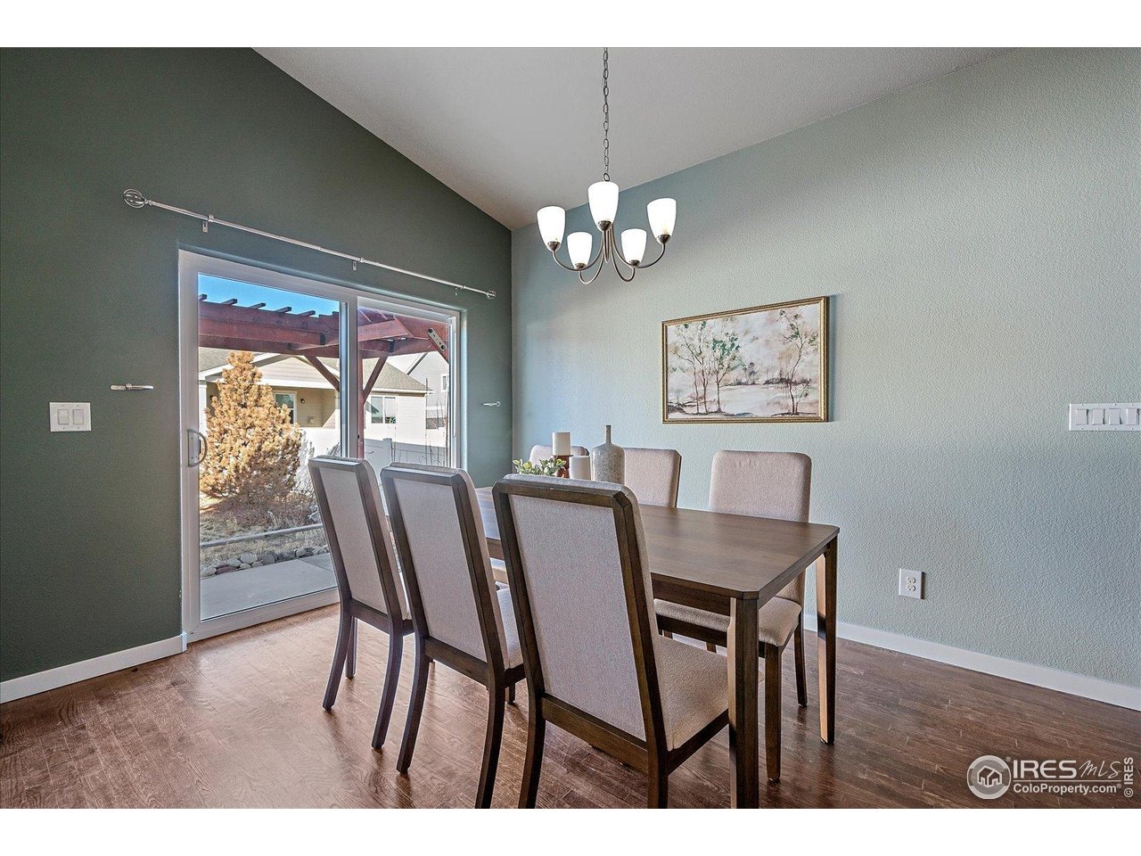 2321 Nicholson Street Berthoud, CO 80513 - Photo 6 of 22 a view of a dining room with furniture a chandelier and wooden floor