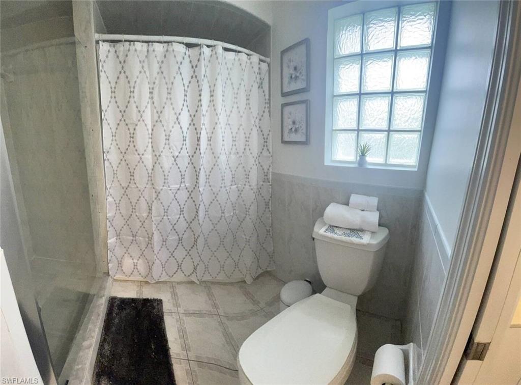3440 15th Avenue Southwest Naples, FL 34117 - Photo 19 of 31 Bathroom featuring walk in shower and toilet