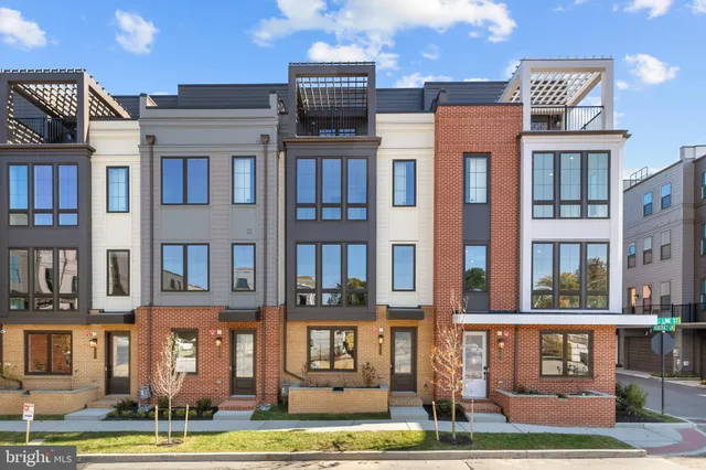 a front view of a residential apartment building with a yard