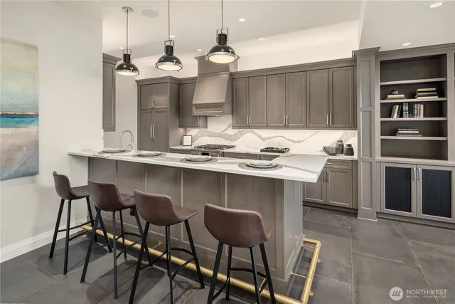 a kitchen with a dining table chairs and cabinets