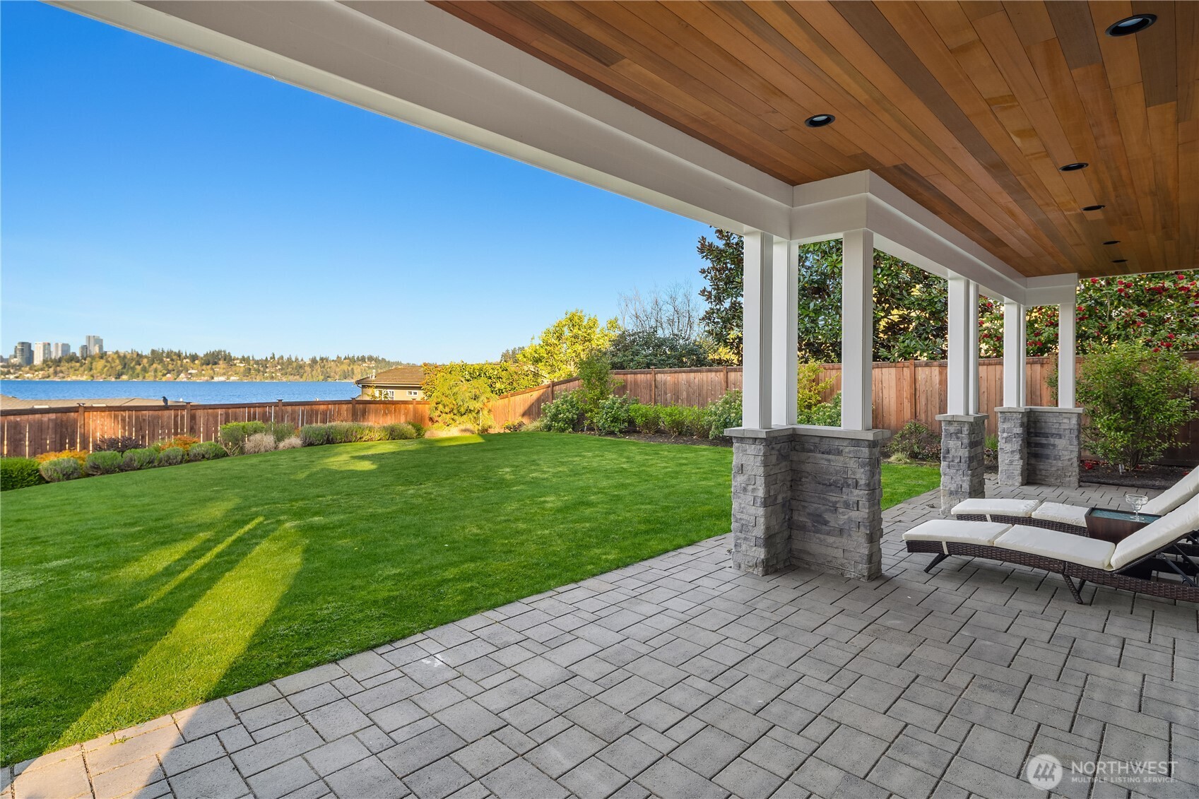 7254 North Mercer Way Mercer Island, WA 98040 - Photo 34 of 37 a view of a patio with table and chairs potted plants and a palm tree
