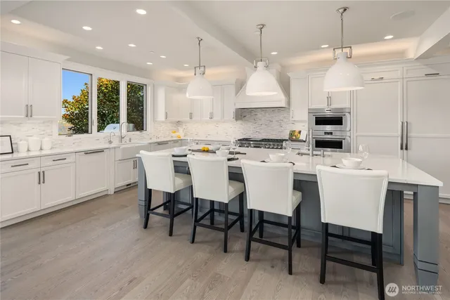 a kitchen with kitchen island a dining table and chairs