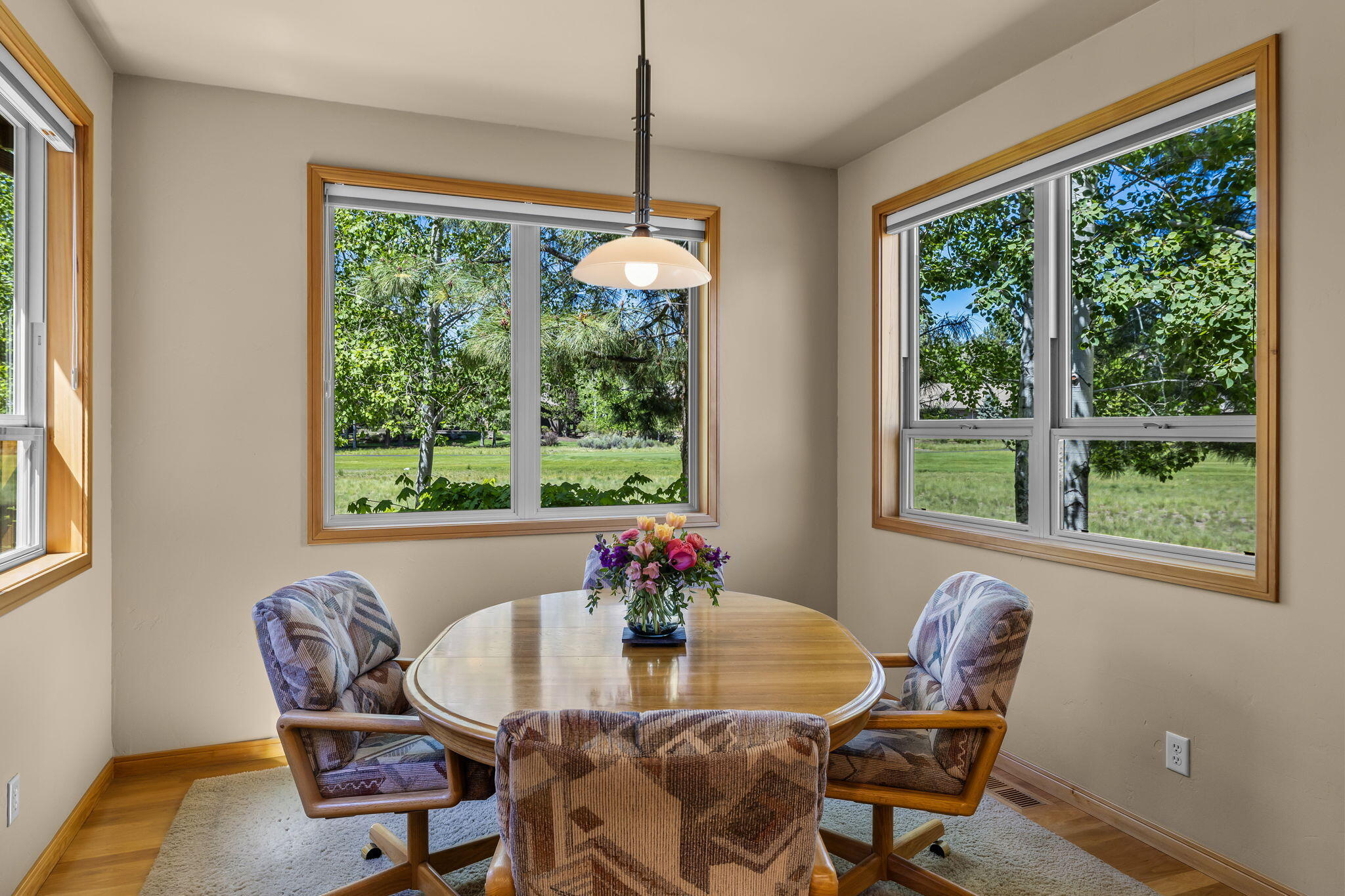 19574 Green Lakes Loop Bend, OR 97702 - Photo 14 of 41 A bright breakfast nook enjoys windows on two sides, bringing in natural light and peaceful views toward the surrounding landscape.