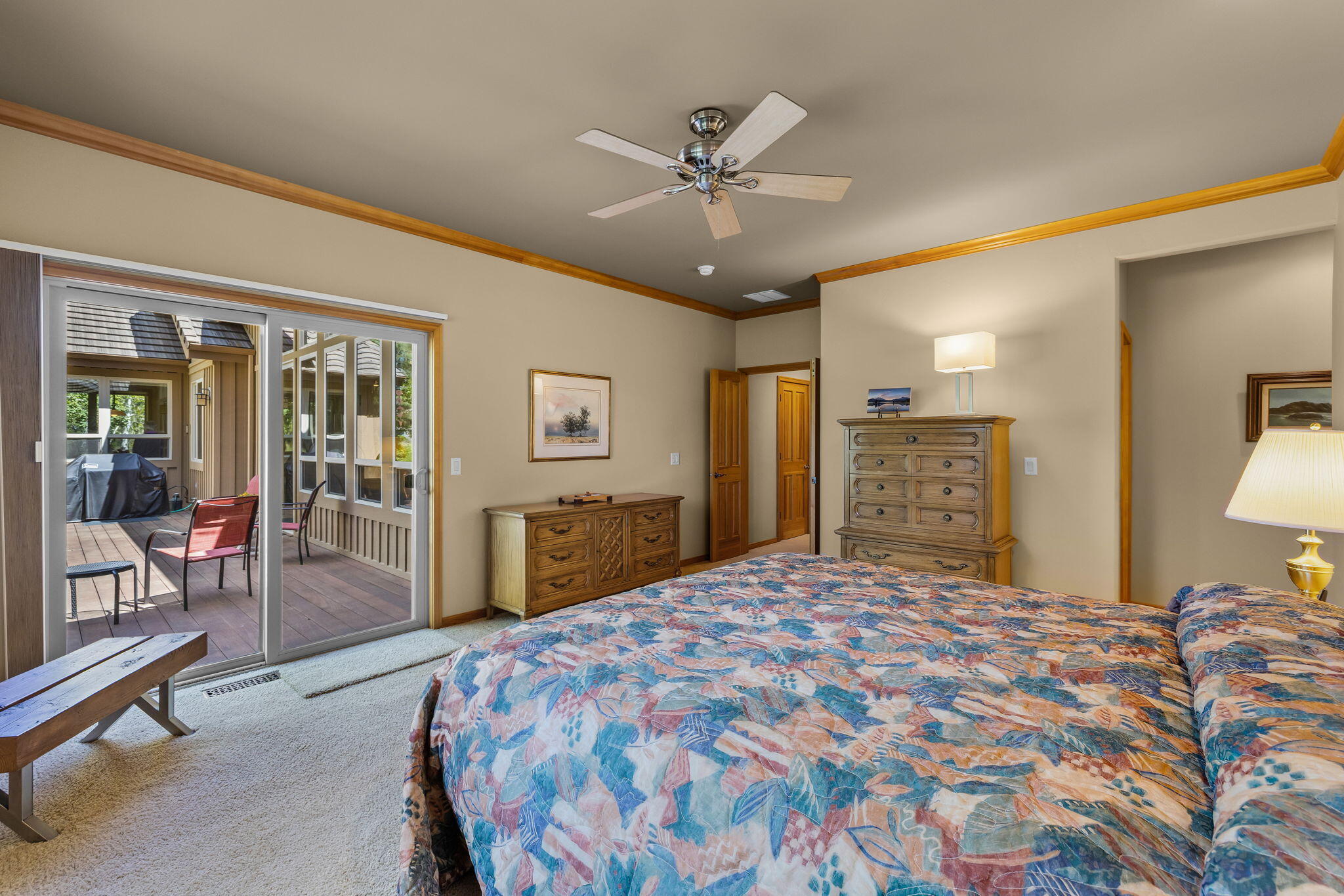 19574 Green Lakes Loop Bend, OR 97702 - Photo 20 of 41 A comfortable primary bedroom with tray ceiling detail, soft natural light, and easy access to the outdoor living area.