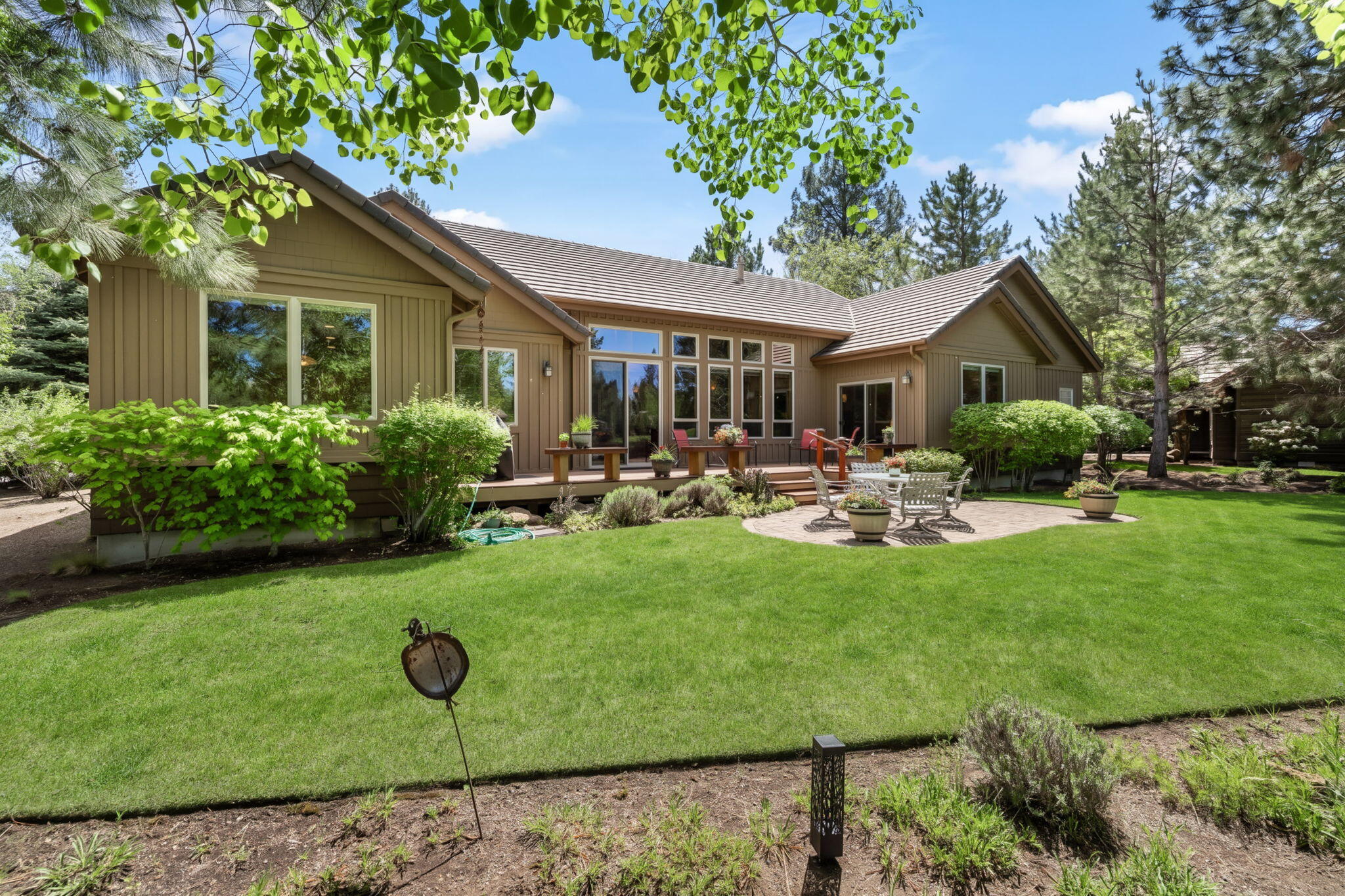 19574 Green Lakes Loop Bend, OR 97702 - Photo 32 of 41 The private backyard enjoys mature landscaping, lawn, patio space, and a peaceful setting along Broken Top?s 17th fairway.